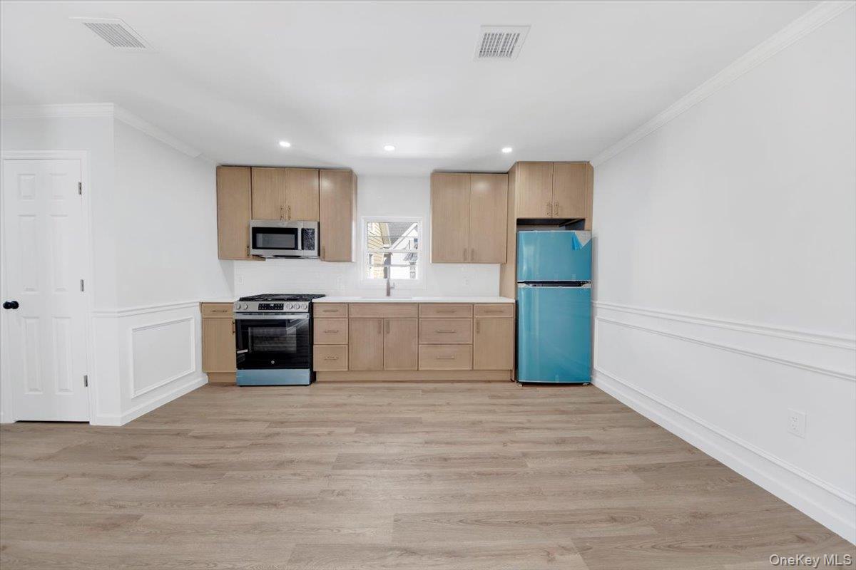 4626 Richardson Avenue, Unit 2 Bronx, NY 10470 - Photo 6 of 20 a large white kitchen with a stove top oven