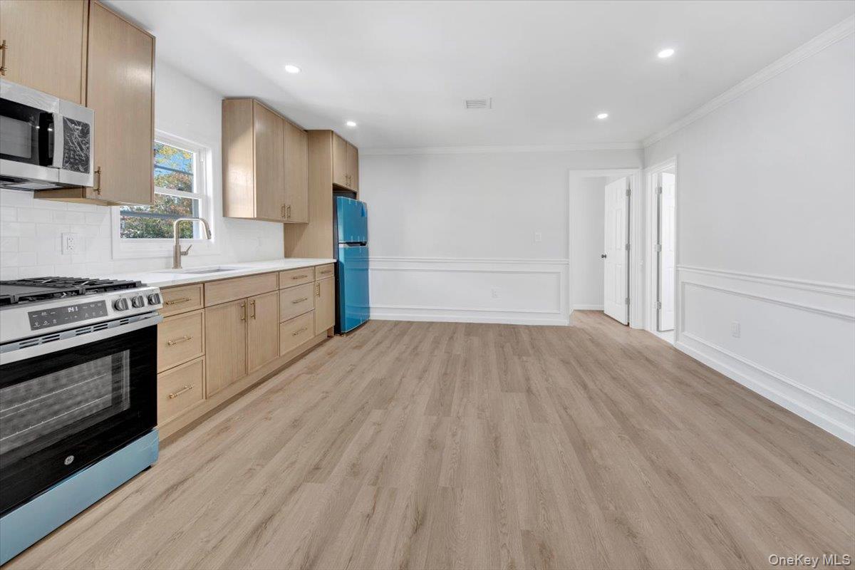 4626 Richardson Avenue, Unit 2 Bronx, NY 10470 - Photo 7 of 20 a view of kitchen with wooden floor electronic appliances and window