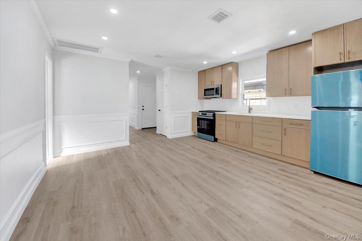 4626 Richardson Avenue, Unit 2 Bronx, NY 10470 - Photo 8 of 20 a large kitchen with cabinets wooden floor and stainless steel appliances