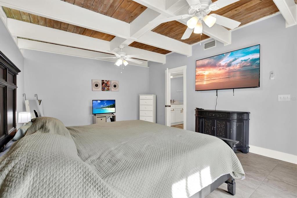 15656 1st Street East Redington Beach, FL 33708 - Photo 13 of 32 a bedroom with a bed and a flat screen tv