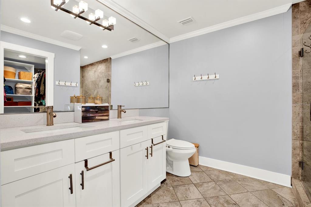 15656 1st Street East Redington Beach, FL 33708 - Photo 14 of 32 a bathroom with a toilet sink and mirror