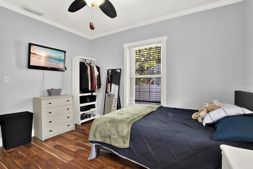 15656 1st Street East Redington Beach, FL 33708 - Photo 18 of 32 a bedroom with a bed and a flat tv screen