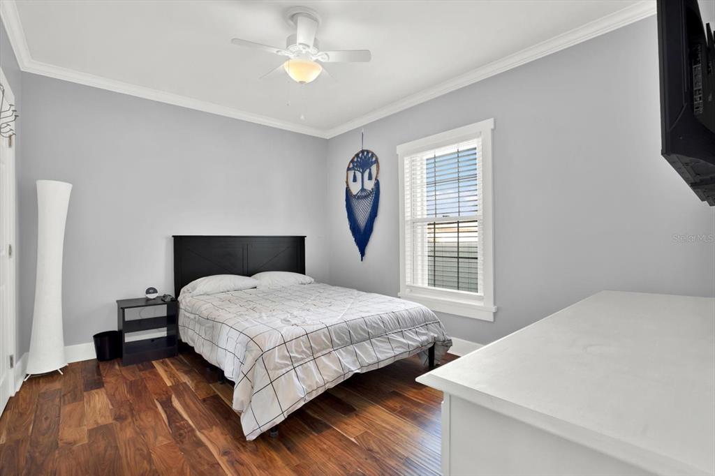 15656 1st Street East Redington Beach, FL 33708 - Photo 20 of 32 a bedroom with a bed lamp and a window