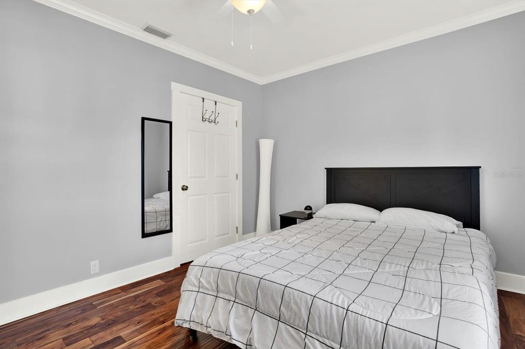 15656 1st Street East Redington Beach, FL 33708 - Photo 21 of 32 a bedroom with a bed and wooden floor