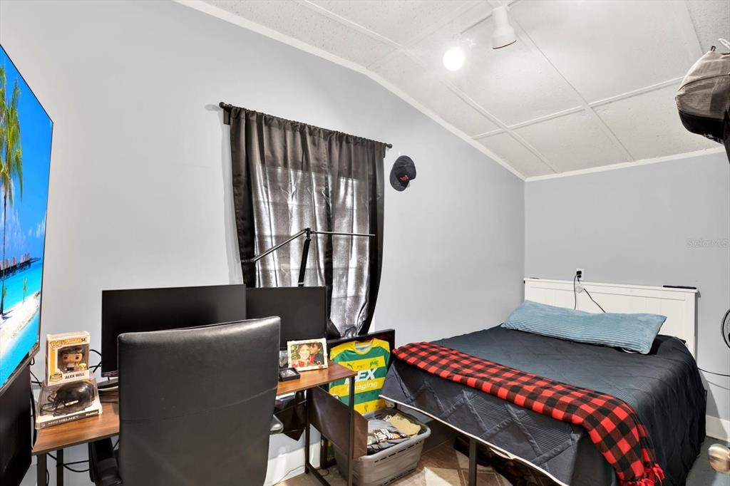 15656 1st Street East Redington Beach, FL 33708 - Photo 22 of 32 a bedroom with a bed and wooden floor