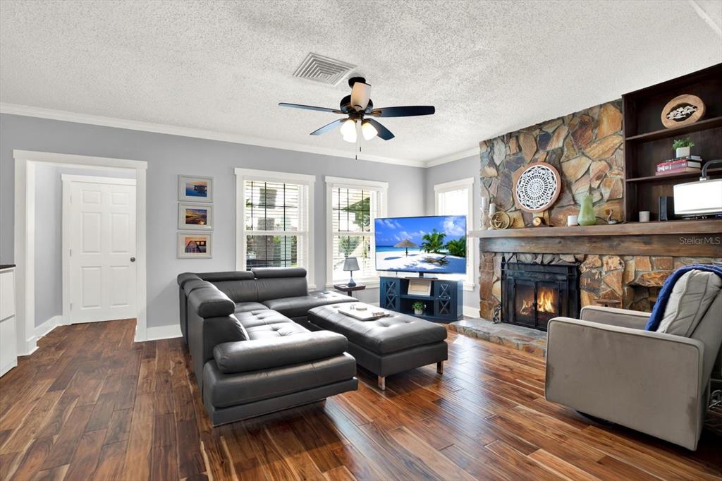 15656 1st Street East Redington Beach, FL 33708 - Photo 3 of 32 a living room with furniture and a fireplace