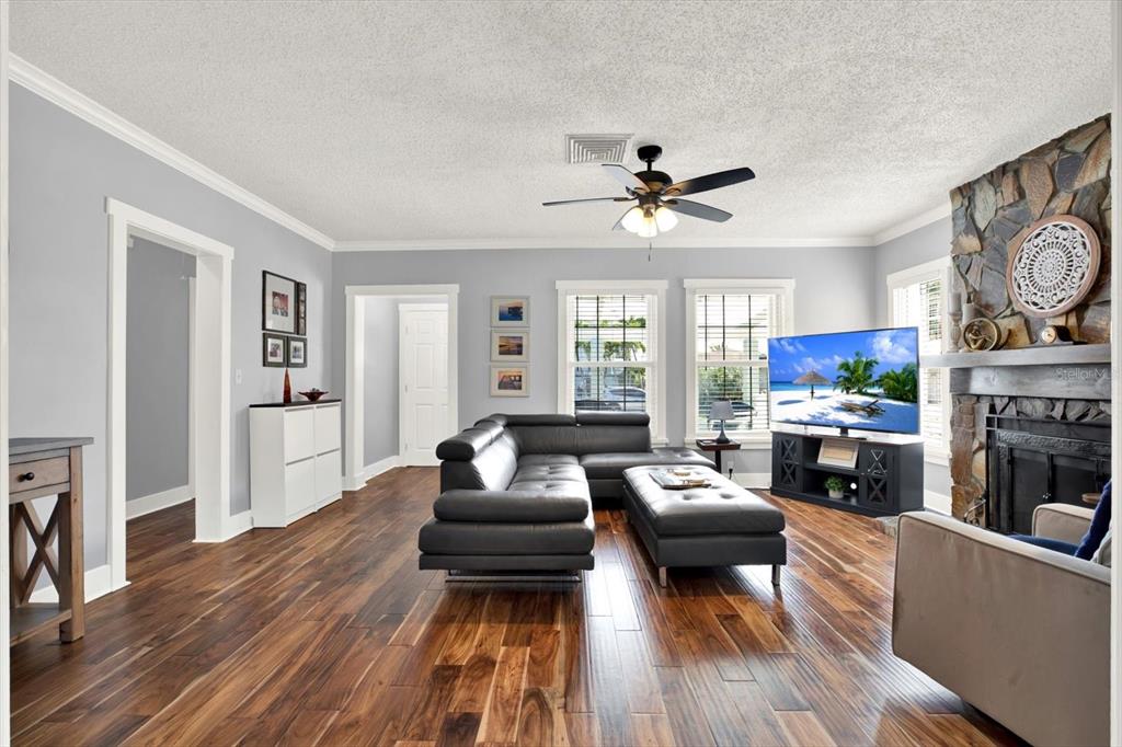 15656 1st Street East Redington Beach, FL 33708 - Photo 4 of 32 a living room with fireplace furniture and a wooden floor