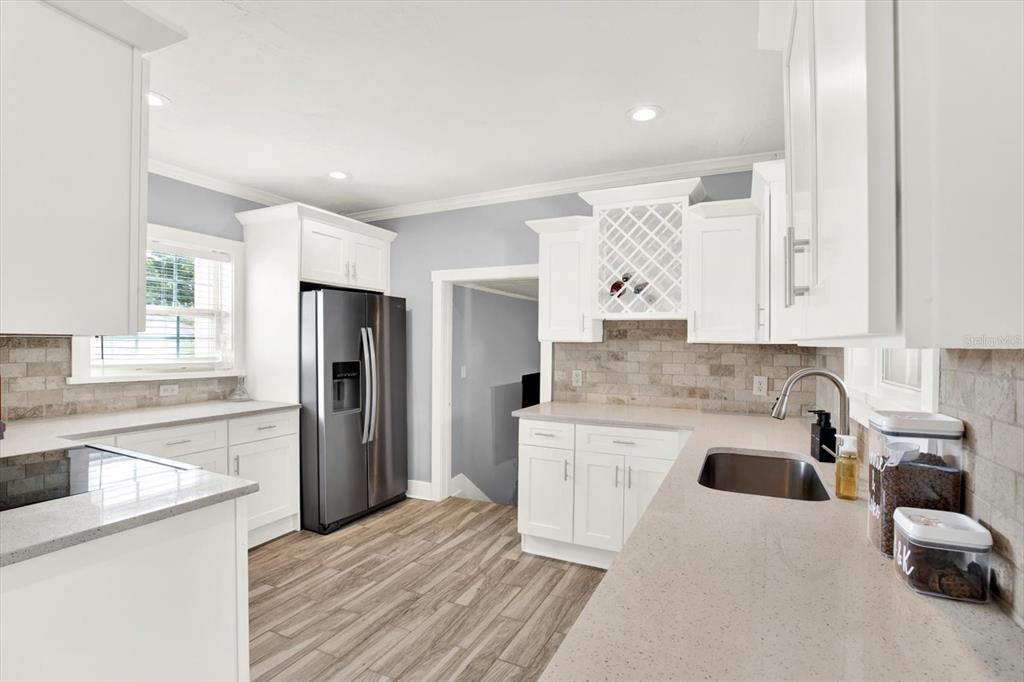 15656 1st Street East Redington Beach, FL 33708 - Photo 7 of 32 a kitchen with a refrigerator and a sink