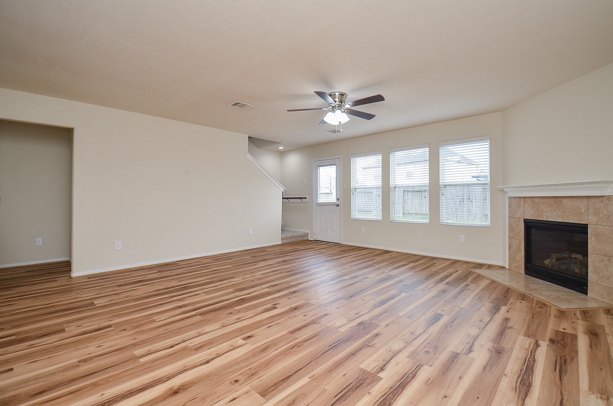 3010 Country Clearing Lane Rosenberg, TX 77471 - Photo 4 of 21 a view of an empty room with a window and wooden floor