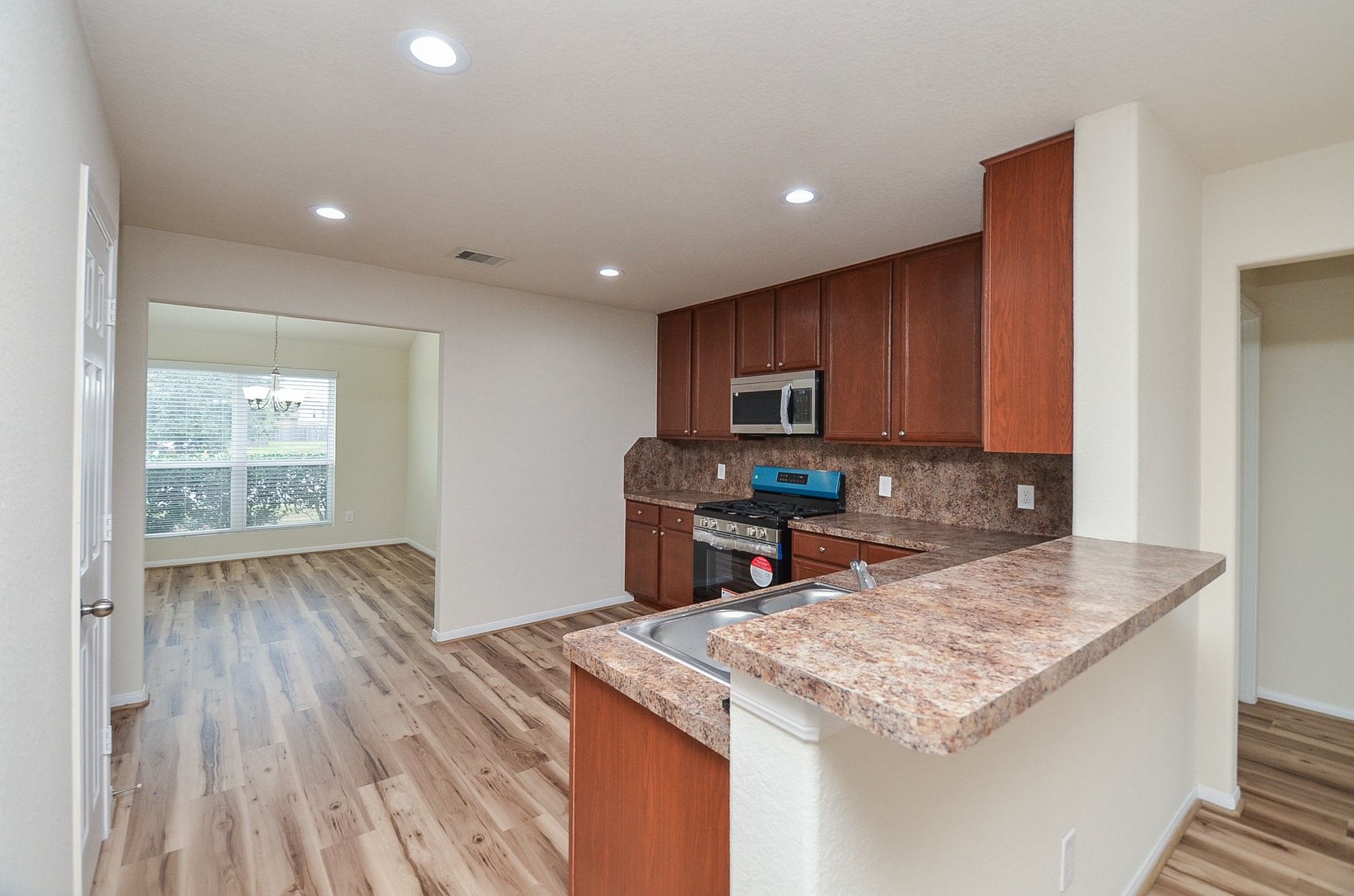3010 Country Clearing Lane Rosenberg, TX 77471 - Photo 7 of 21 a kitchen with stainless steel appliances granite countertop a sink stove and cabinets