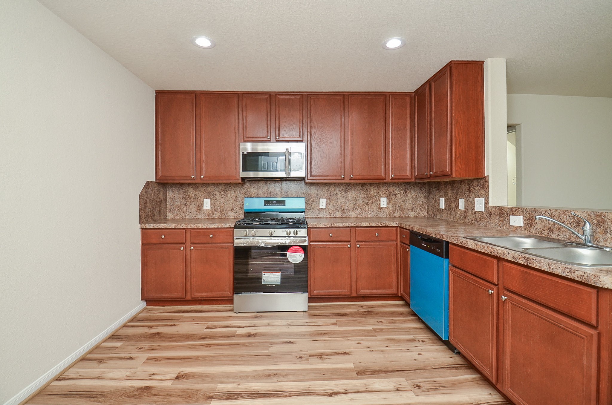 3010 Country Clearing Lane Rosenberg, TX 77471 - Photo 8 of 21 a kitchen with stainless steel appliances granite countertop a stove a sink and a refrigerator