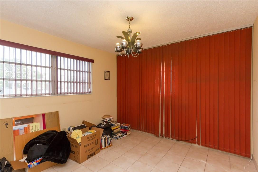 3300 Southwest 94th Court Miami, FL 33165 - Photo 14 of 18 a bed room with a bed and a chandelier