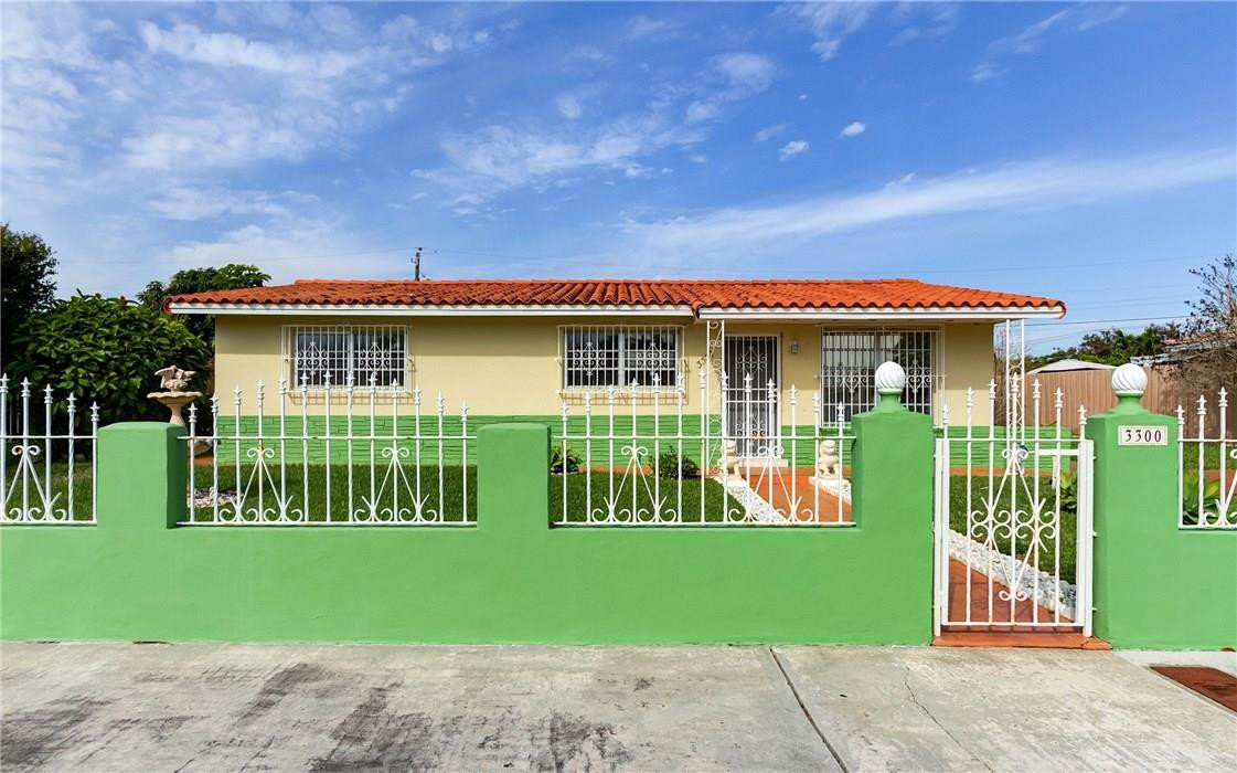3300 Southwest 94th Court Miami, FL 33165 - Photo 2 of 18 a front view of a house with a garden