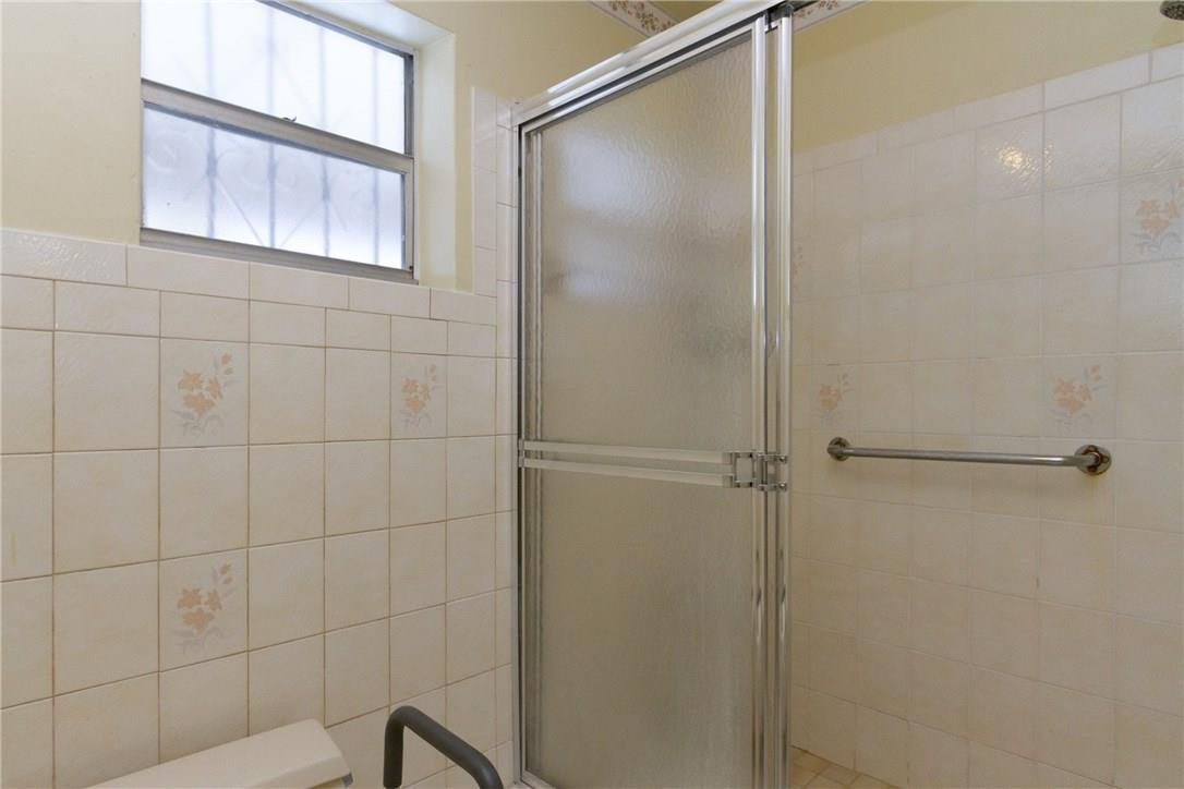 3300 Southwest 94th Court Miami, FL 33165 - Photo 6 of 18 a bathroom with a glass shower door