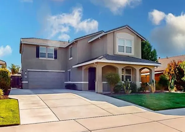 a front view of a house with garden