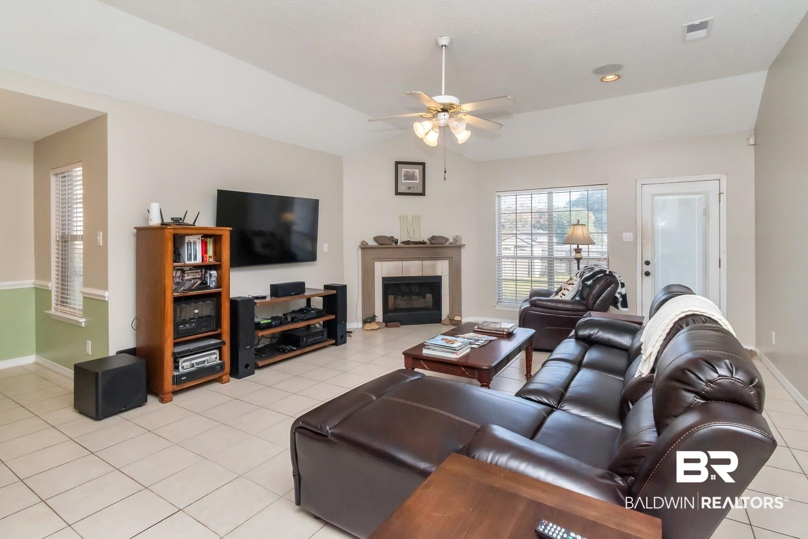 29221 Canterbury Road Daphne, AL 36526 - Photo 4 of 17 Tiled living room with ceiling fan, lofted ceiling, and a tiled fireplace