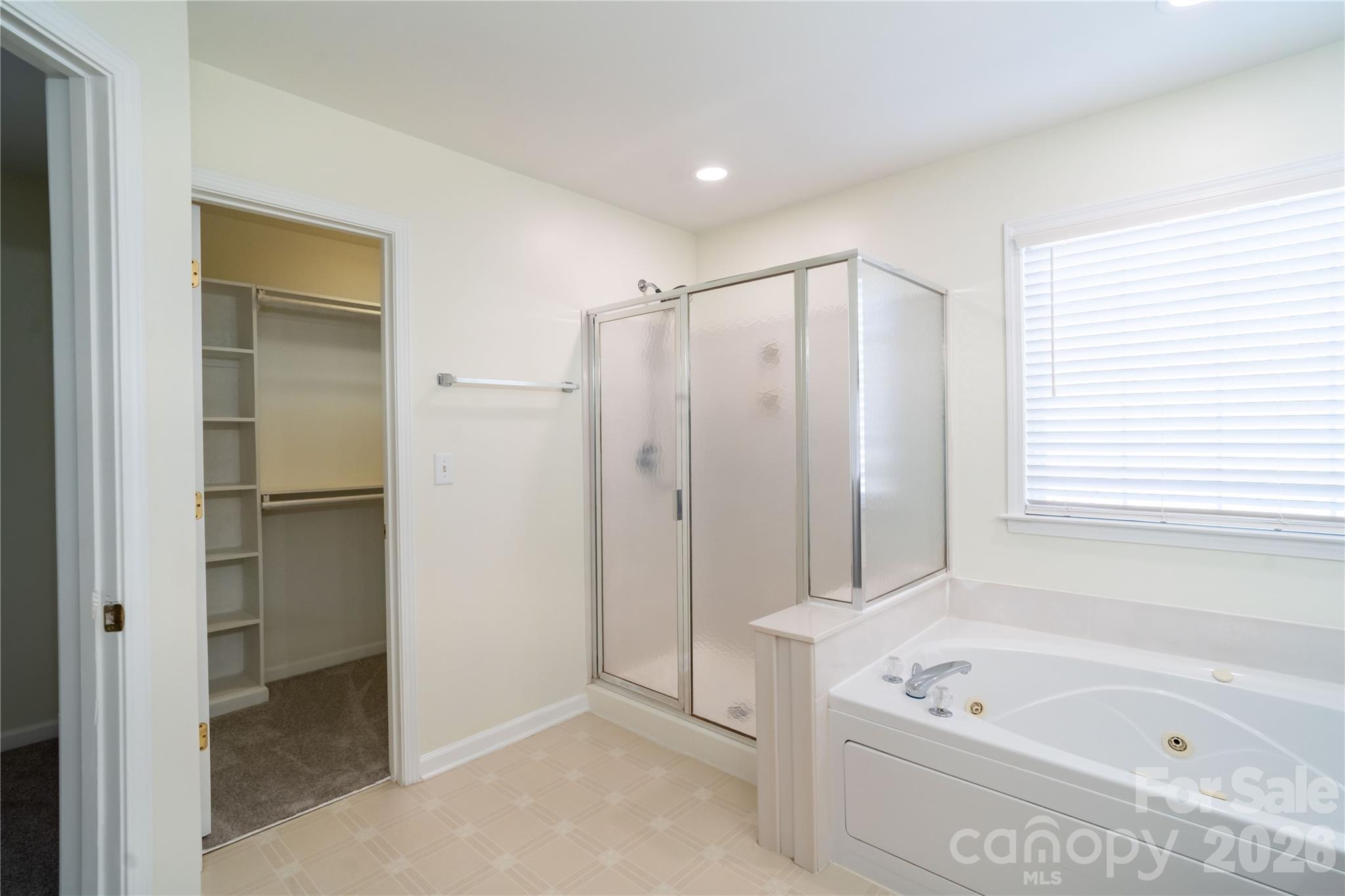 16905 Laureate Road, Unit 16 Huntersville, NC 28078 - Photo 30 of 38 a bathroom with a tub a window and a shower
