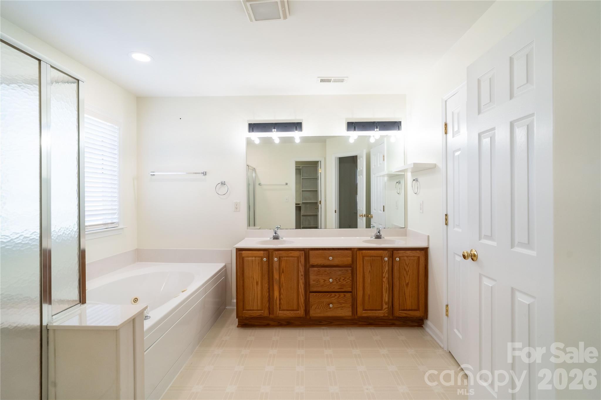 16905 Laureate Road, Unit 16 Huntersville, NC 28078 - Photo 32 of 38 a spacious bathroom with a tub sink and mirror