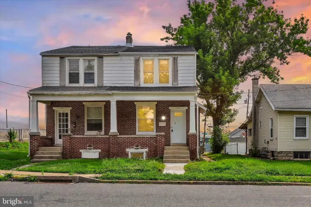 a front view of a house with a yard and a garage