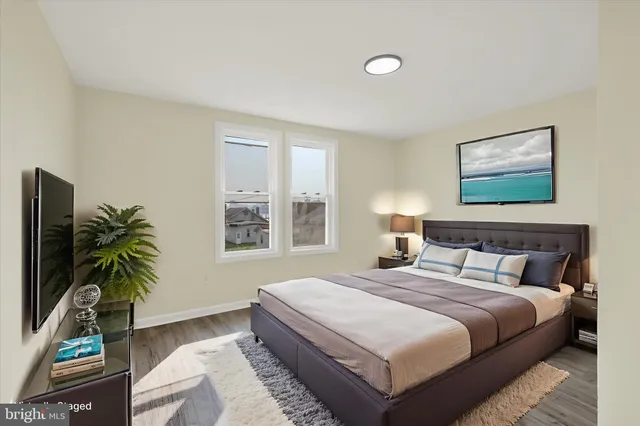 a bedroom with bed and a potted plant