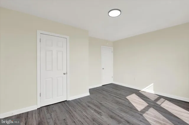 an empty room with wooden floor