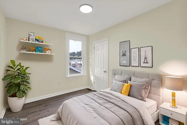 a bedroom with a bed and a potted plant
