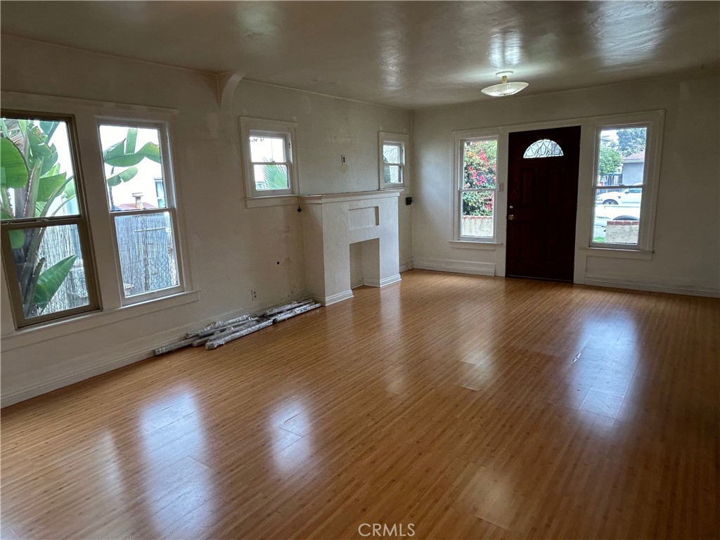 2285 Pine Avenue Long Beach, CA 90806 - Photo 14 of 25 an empty room with wooden floor and windows