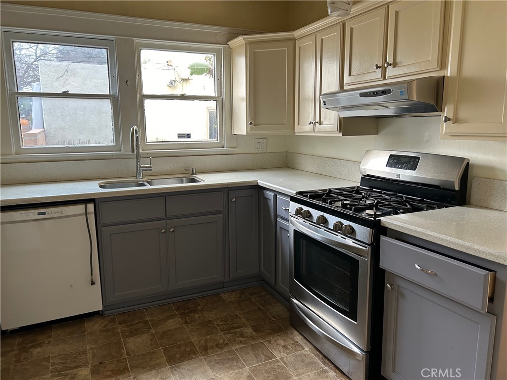 2285 Pine Avenue Long Beach, CA 90806 - Photo 18 of 25 a kitchen with stainless steel appliances granite countertop a sink stove oven and window