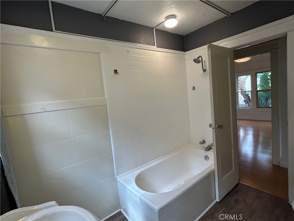 2285 Pine Avenue Long Beach, CA 90806 - Photo 21 of 25 a bathroom with a bathtub and a shower