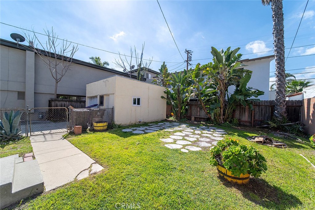 2285 Pine Avenue Long Beach, CA 90806 - Photo 5 of 25 a view of a backyard with couches plants and large tree
