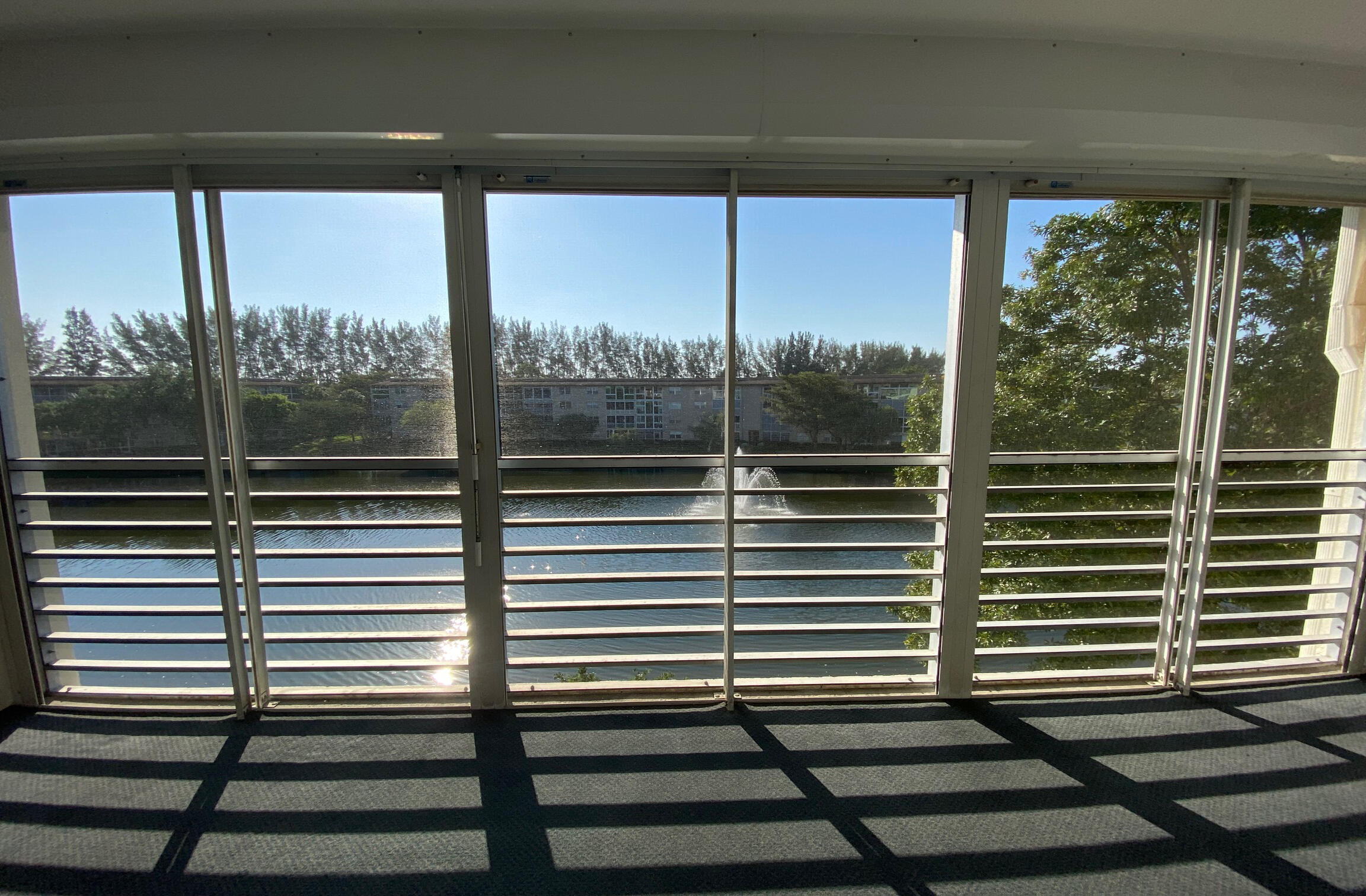 a view of a balcony with a floor to ceiling window and wooden floor