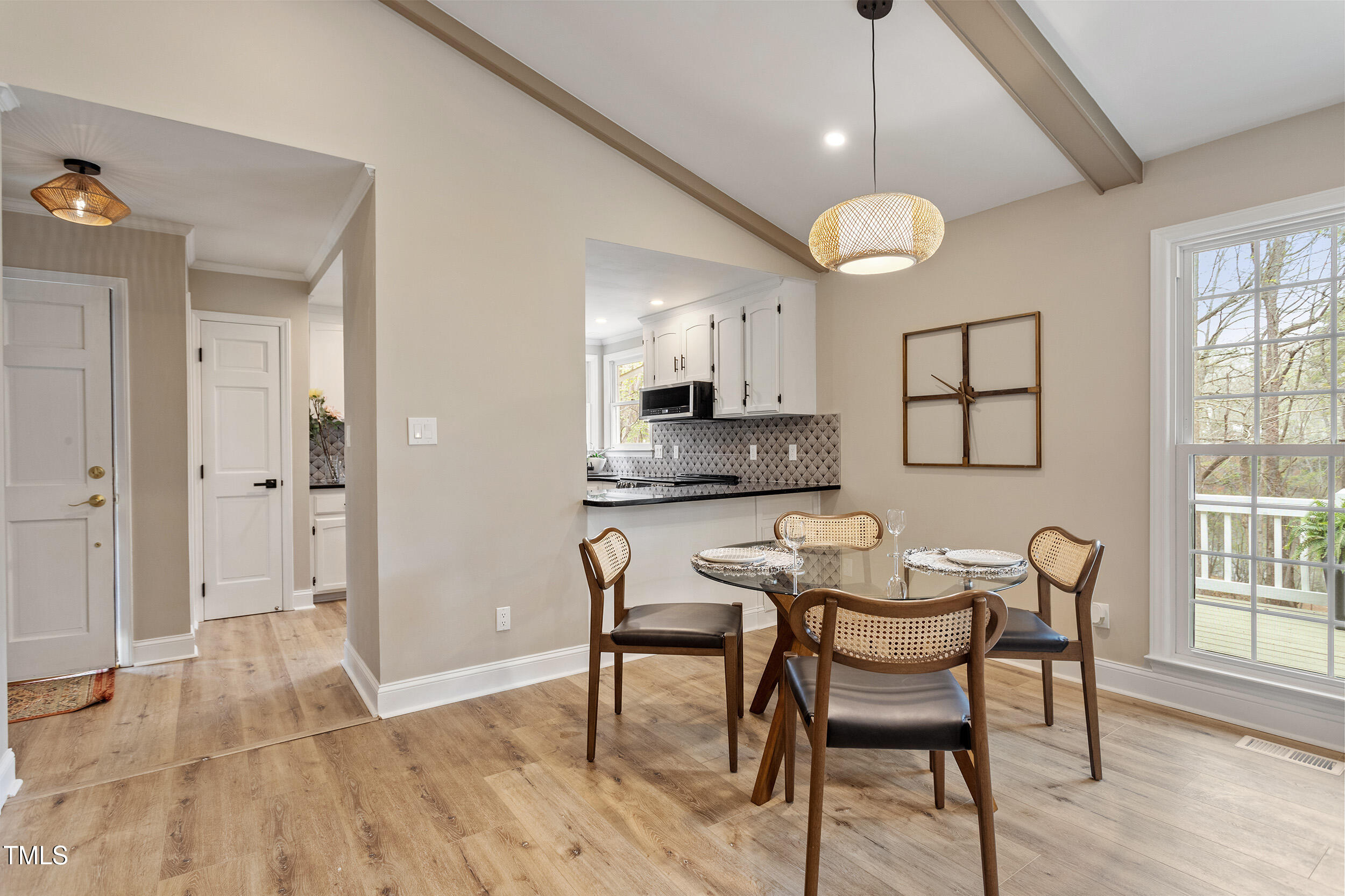 7825 Breckon Way Raleigh, NC 27615 - Photo 12 of 32 a view of a a dining room with furniture window and wooden floor
