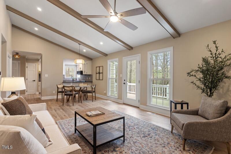 7825 Breckon Way Raleigh, NC 27615 - Photo 14 of 32 a living room with furniture and a large window