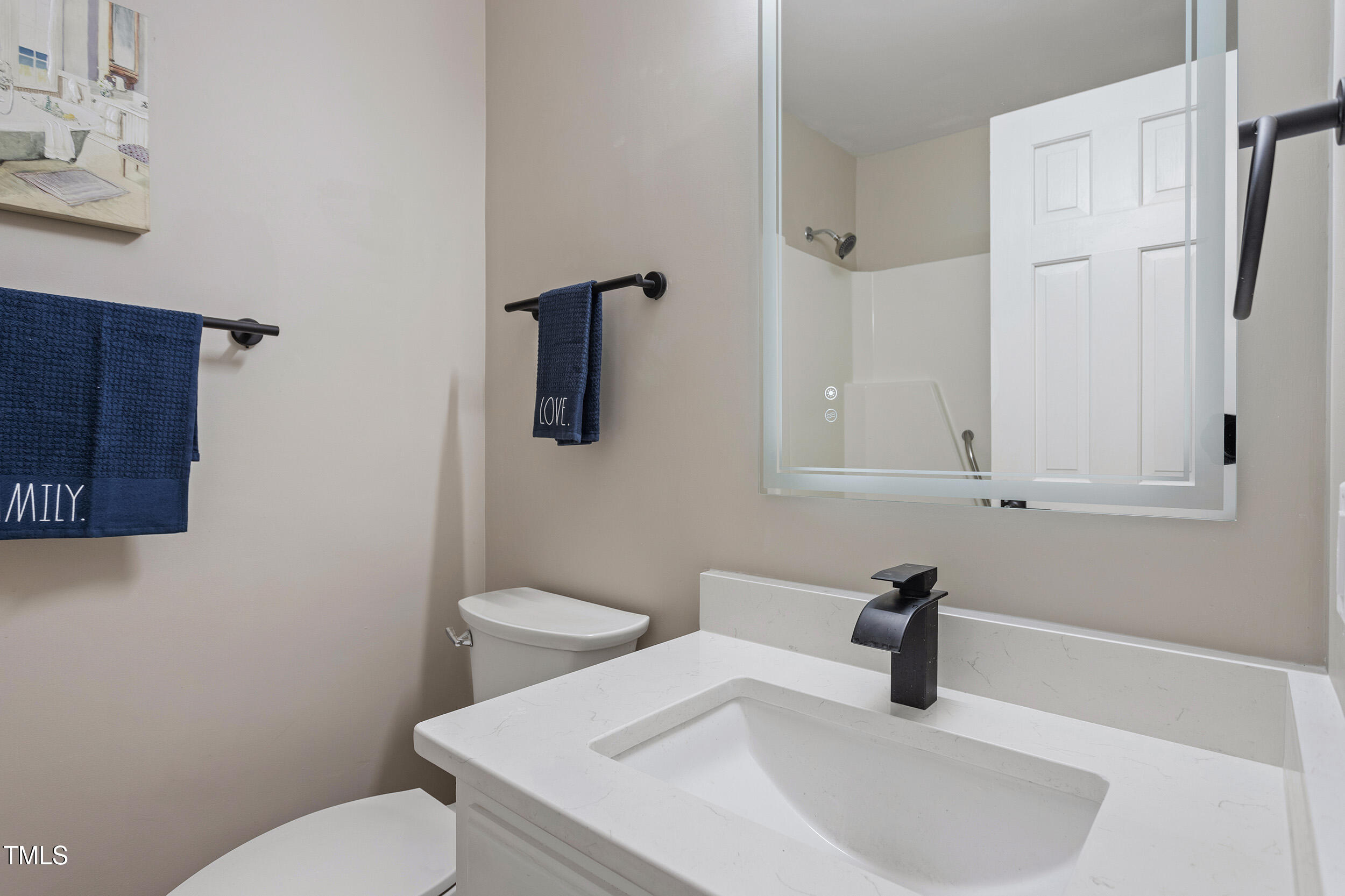 7825 Breckon Way Raleigh, NC 27615 - Photo 18 of 32 a bathroom with a sink and a toilet