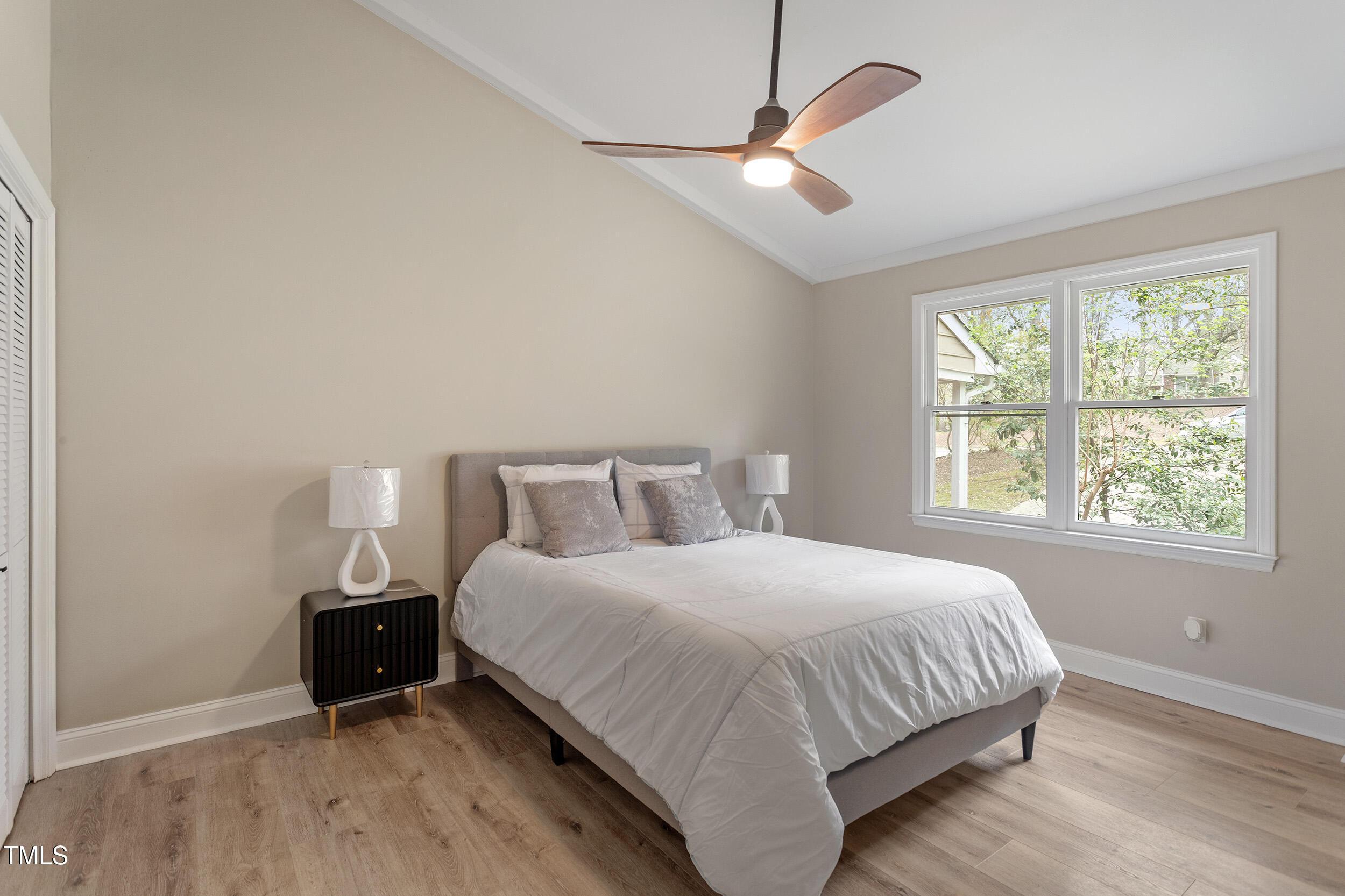 7825 Breckon Way Raleigh, NC 27615 - Photo 19 of 32 a bedroom with a bed and a window