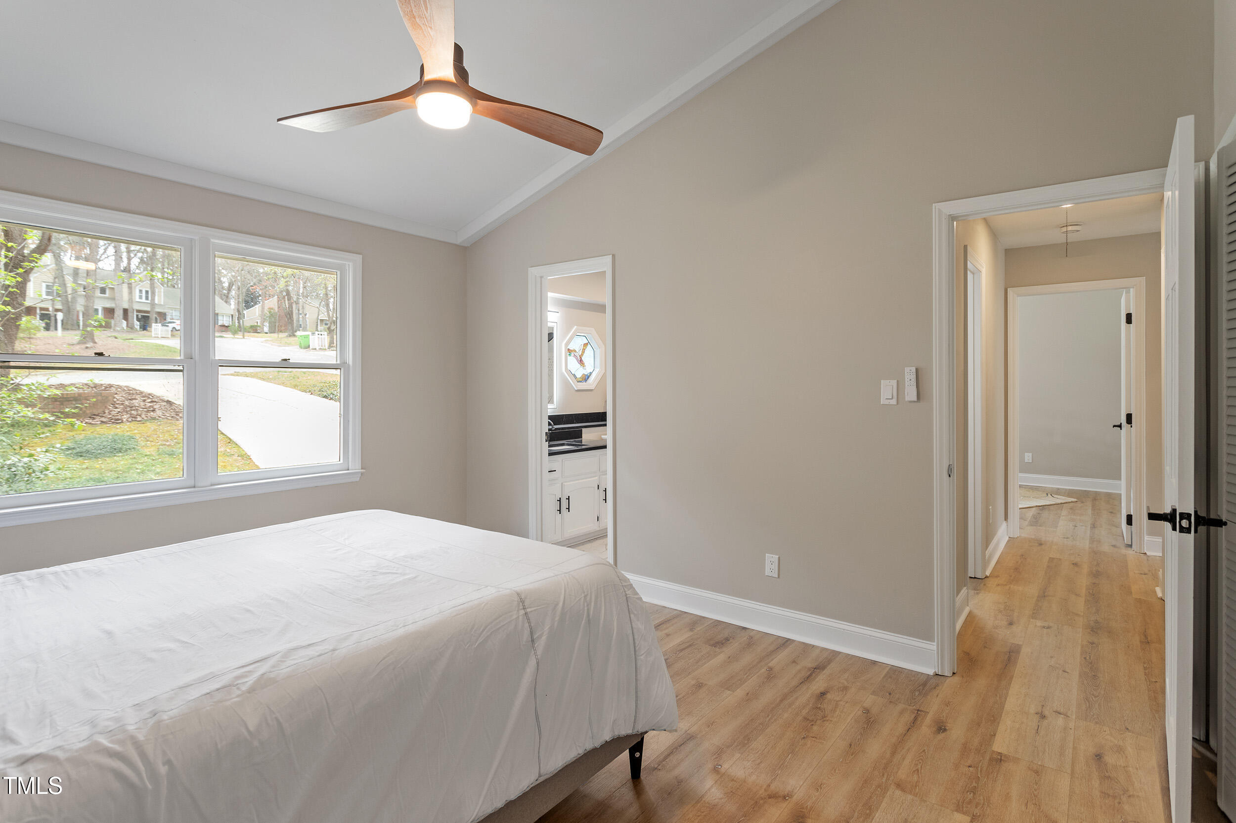 7825 Breckon Way Raleigh, NC 27615 - Photo 20 of 32 a spacious bedroom with a bed and a window