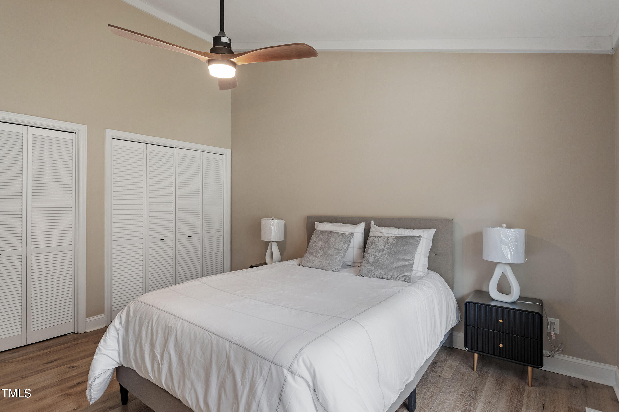 7825 Breckon Way Raleigh, NC 27615 - Photo 21 of 32 a bedroom with a bed and a night stand