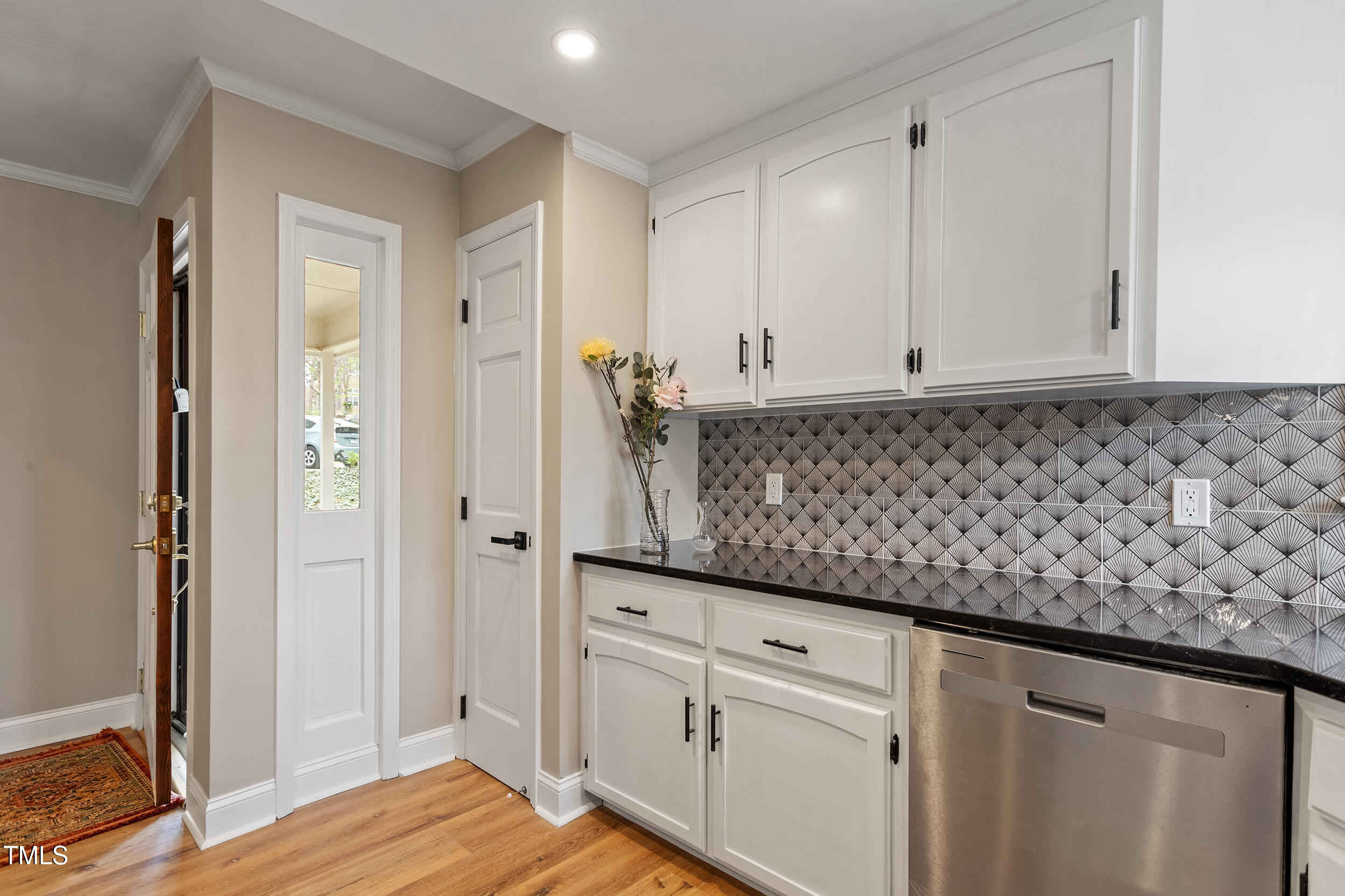 7825 Breckon Way Raleigh, NC 27615 - Photo 9 of 32 a view of a kitchen counter space and wooden floor
