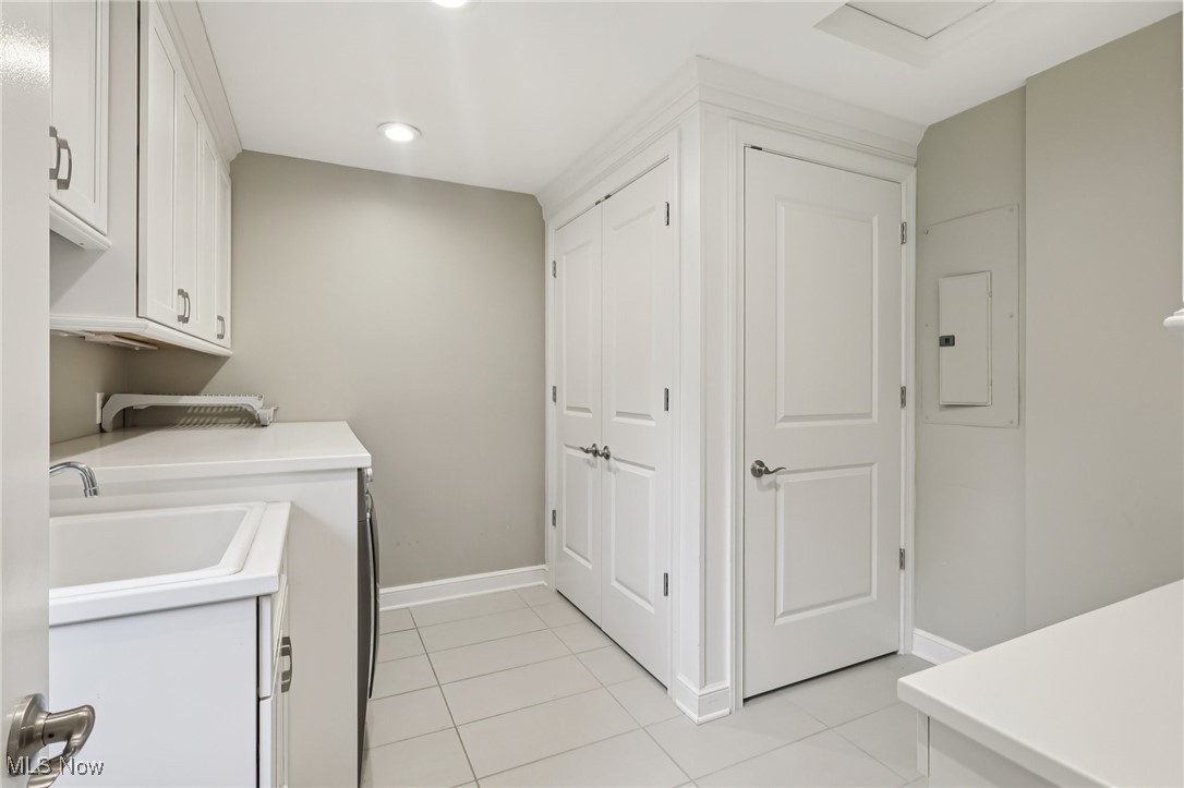 33300 South Woodland Road Cleveland, OH 44124 - Photo 27 of 50 Laundry area featuring light tile patterned floors, electric panel, recessed lighting, and washer / dryer