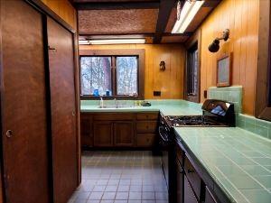 63 Ross Hollow Road New Kensington, PA 15068 - Photo 8 of 15 a kitchen with a sink a stove cabinets and a wooden floor