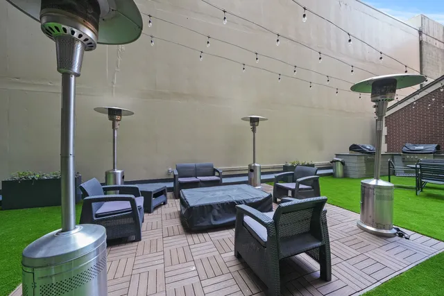 a view of a patio with couches table and chairs with plants and garden
