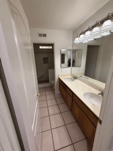 a bathroom with a sink vanity and mirror