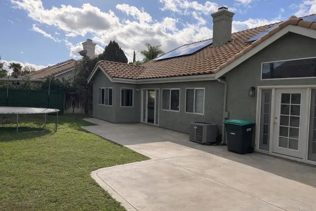 a front view of a house with a garden and plants