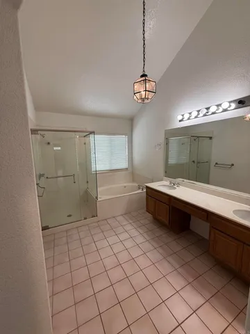 a spacious bathroom with a granite countertop sink mirror and shower