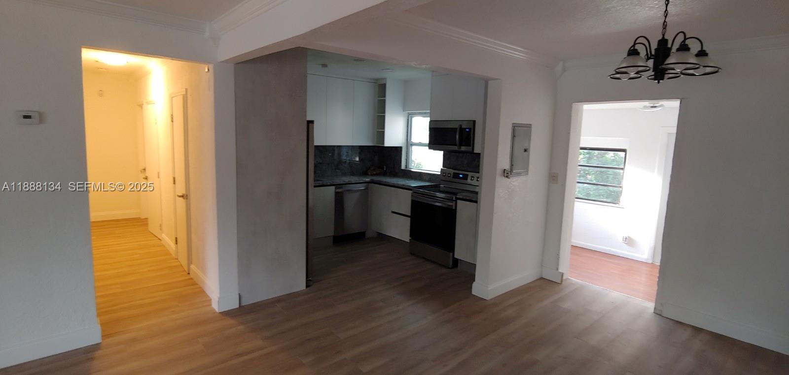 5770 Southwest 62nd Terrace Miami, FL 33143 - Photo 12 of 17 a kitchen with a refrigerator and a stove top oven