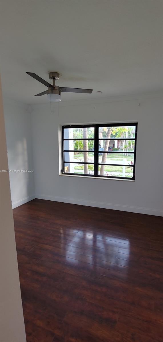 5770 Southwest 62nd Terrace Miami, FL 33143 - Photo 15 of 17 a view of an empty room with wooden floor and a window