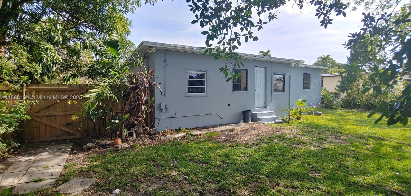 5770 Southwest 62nd Terrace Miami, FL 33143 - Photo 17 of 17 a view of a yard in front of a house with large tree