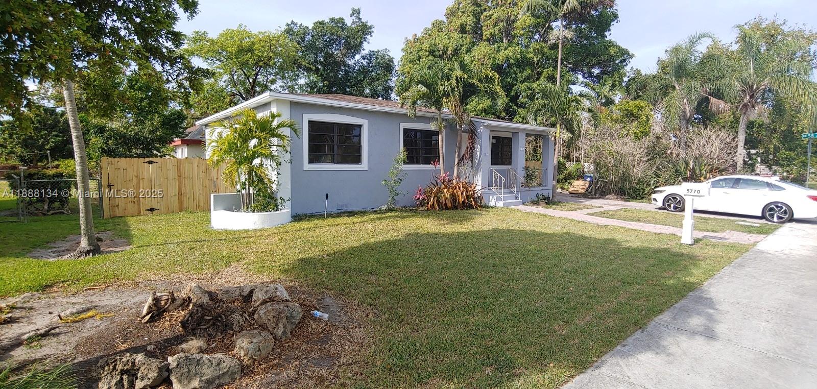 5770 Southwest 62nd Terrace Miami, FL 33143 - Photo 3 of 17 a view of a house with backyard and trees