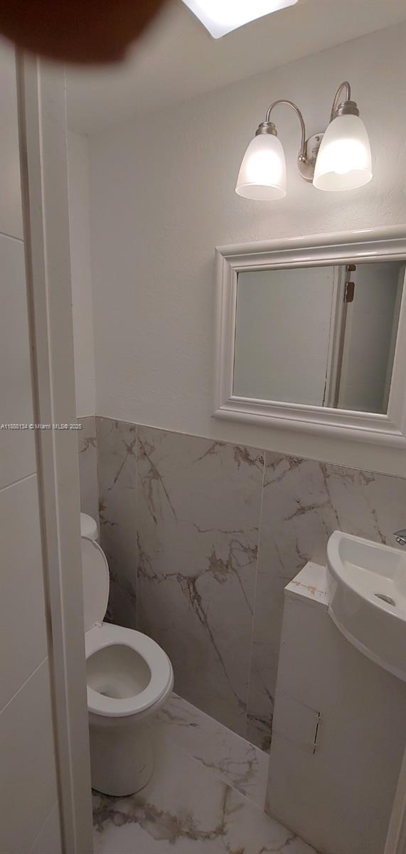 5770 Southwest 62nd Terrace Miami, FL 33143 - Photo 7 of 17 a bathroom with a toilet and a sink