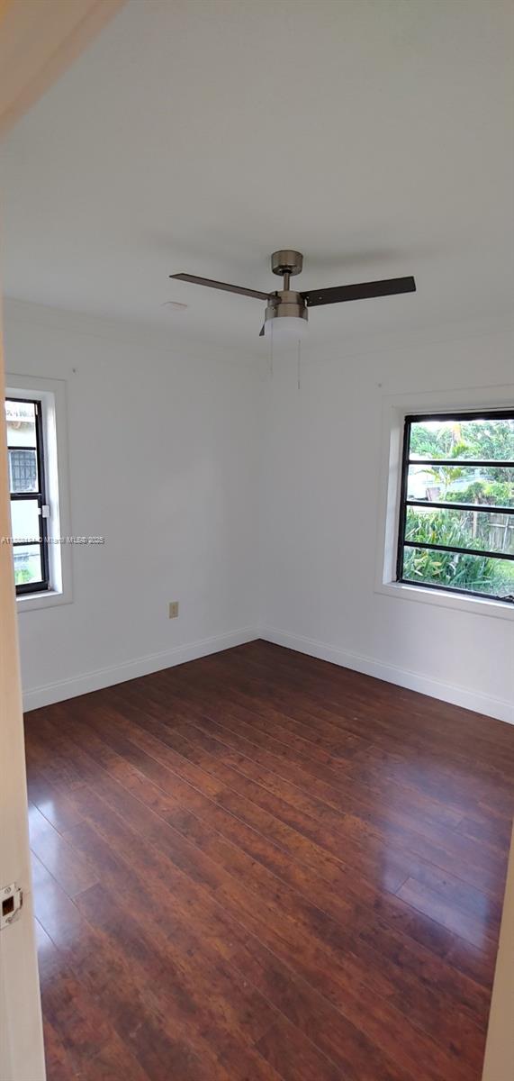 5770 Southwest 62nd Terrace Miami, FL 33143 - Photo 9 of 17 a view of an empty room with wooden floor and a window